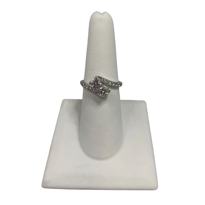 A white ring holder with a ring on it