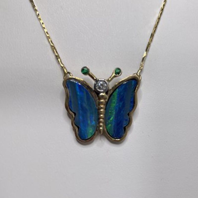 A necklace with a blue butterfly shaped pendant
