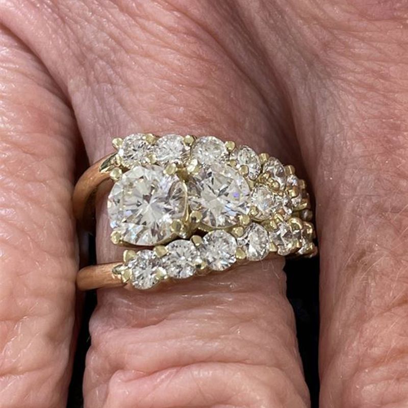 A close up of a person 's hand with a ring on it