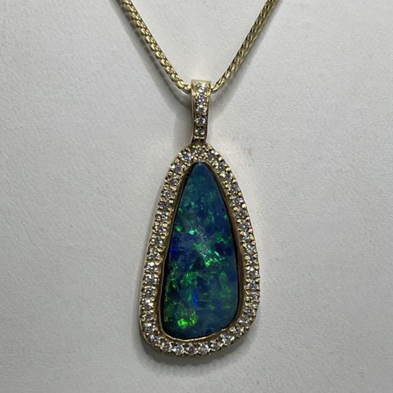 A necklace with a black opal surrounded by diamonds
