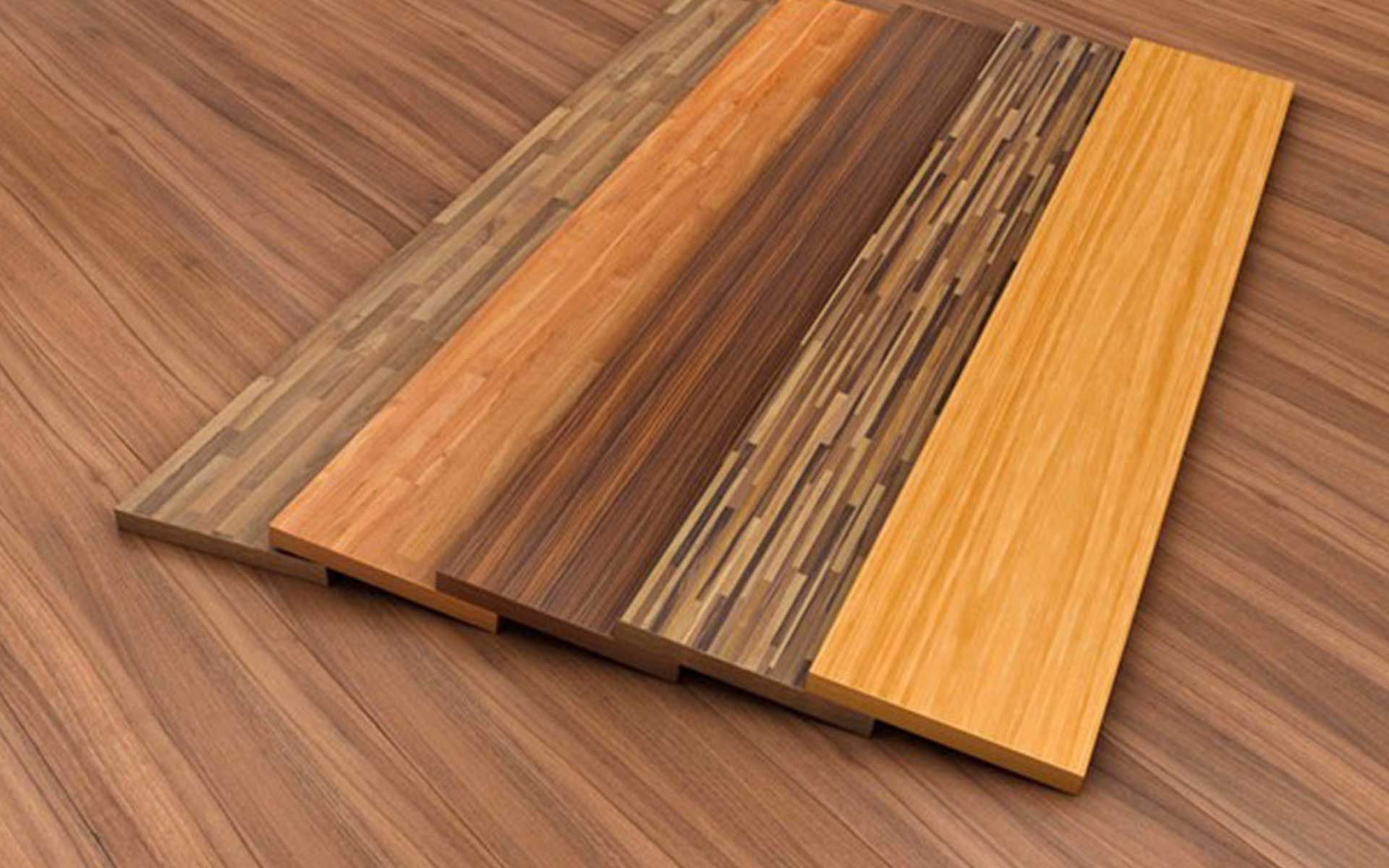 Three pieces of wood are stacked on top of each other on a wooden floor