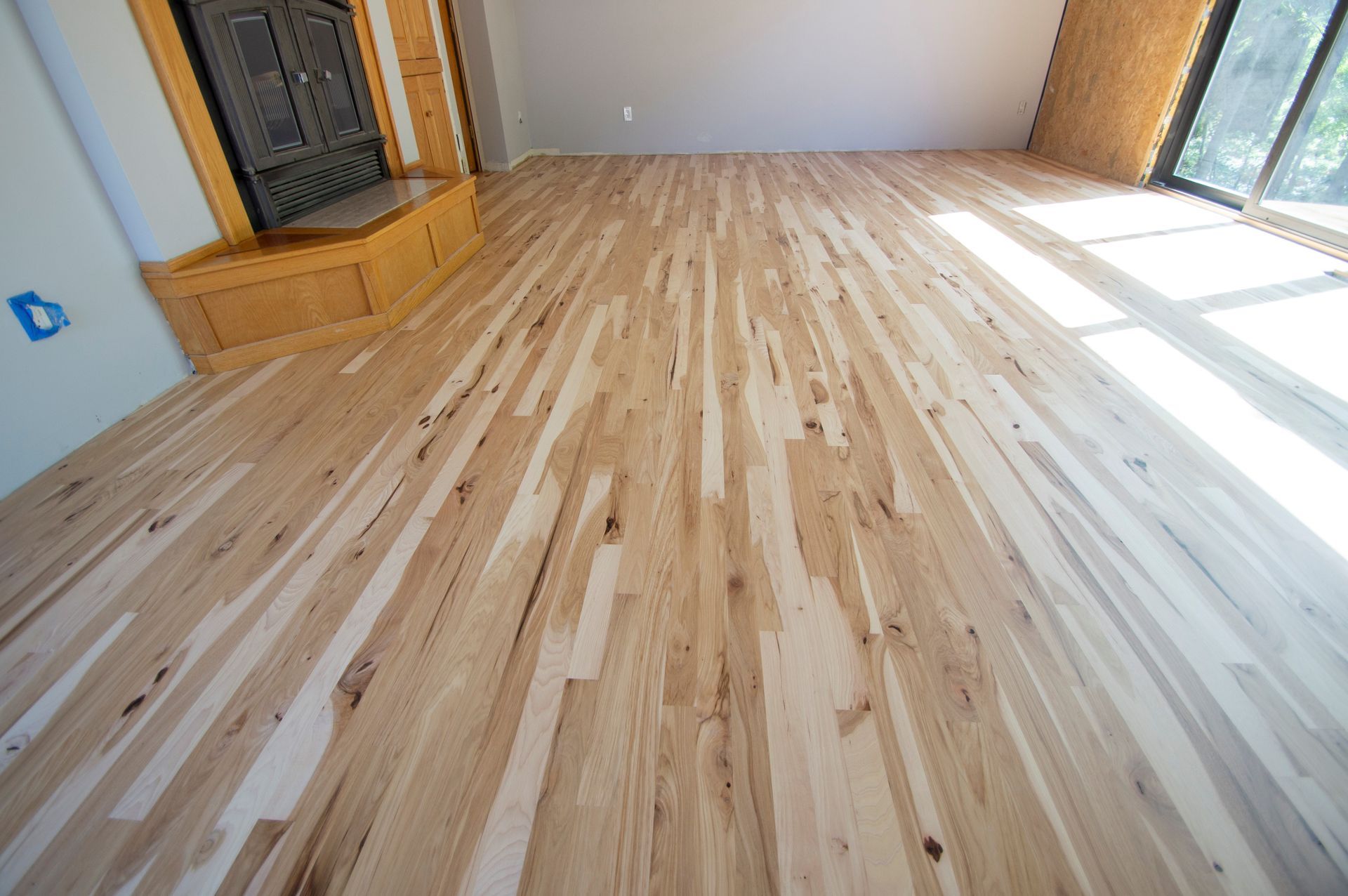 A living room with hardwood floors and a fireplace.