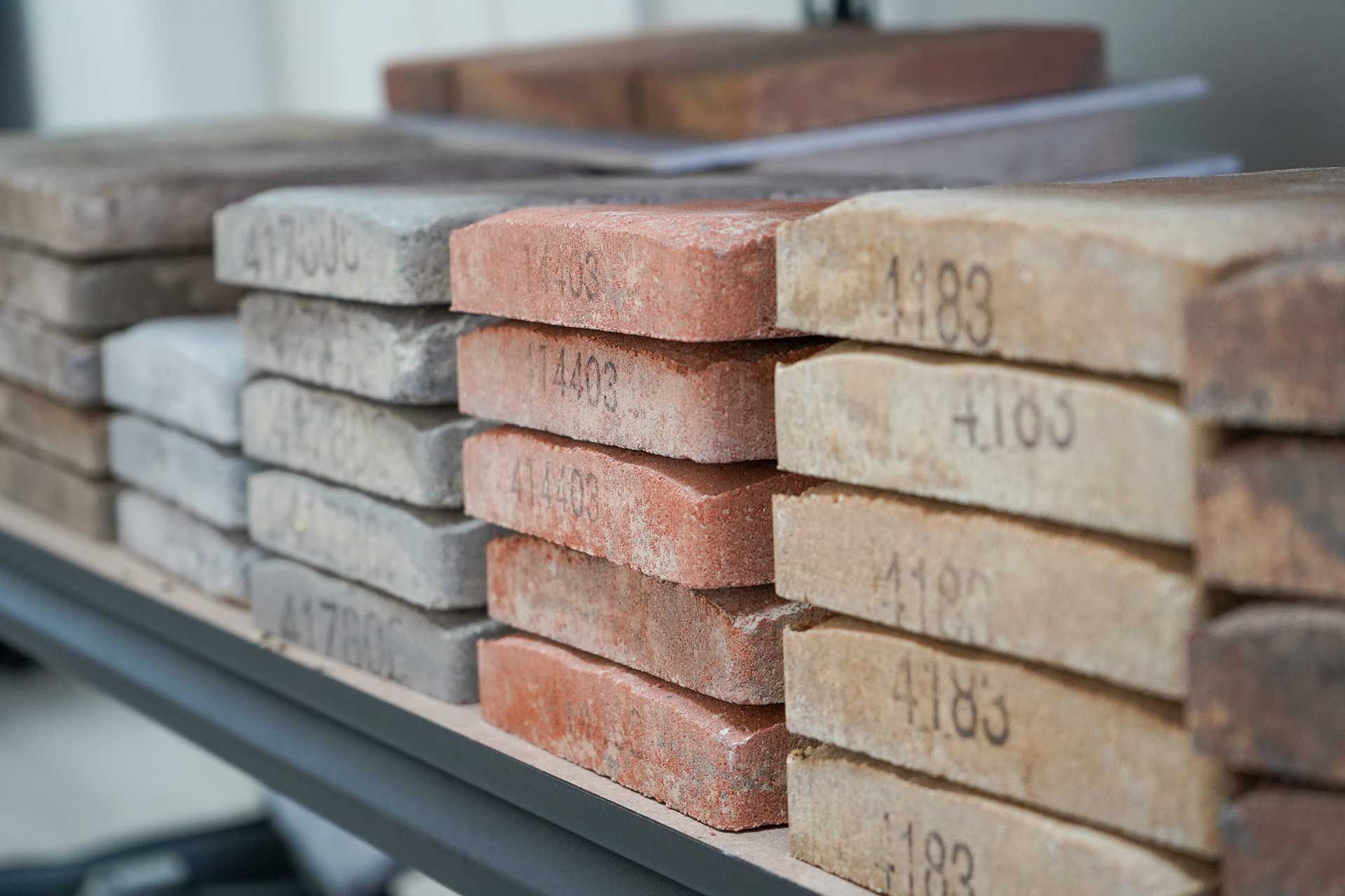 a shelf filled with pavers of different colors and sizes