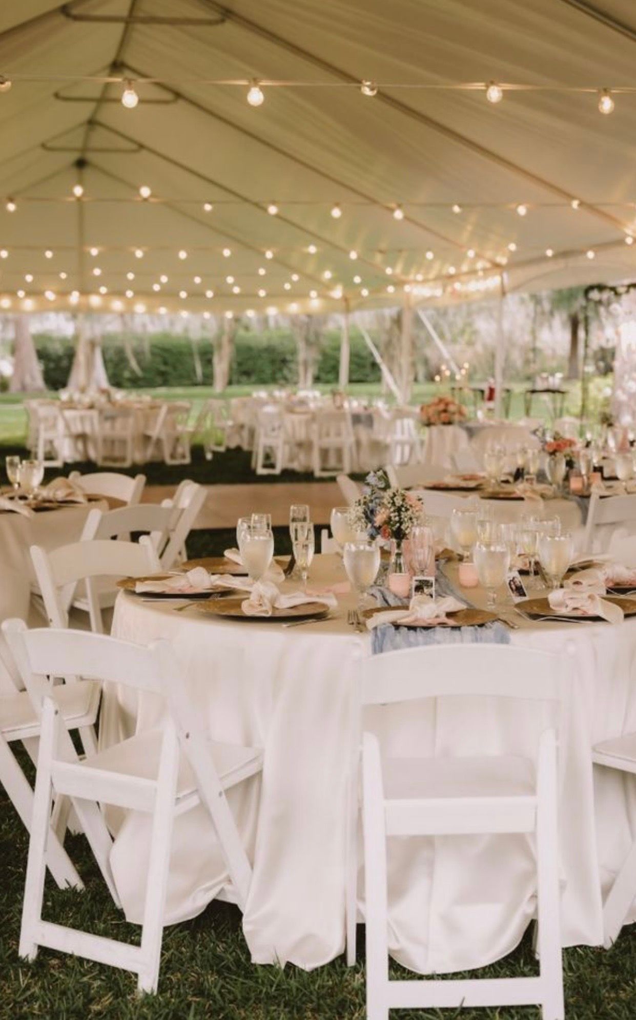 Elegant tented wedding reception with round tables