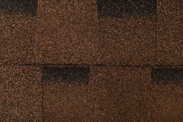 A close up of a brown and black roof tile.