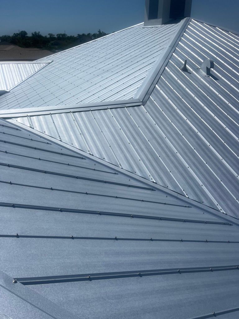 A metal roof with a chimney on top of it