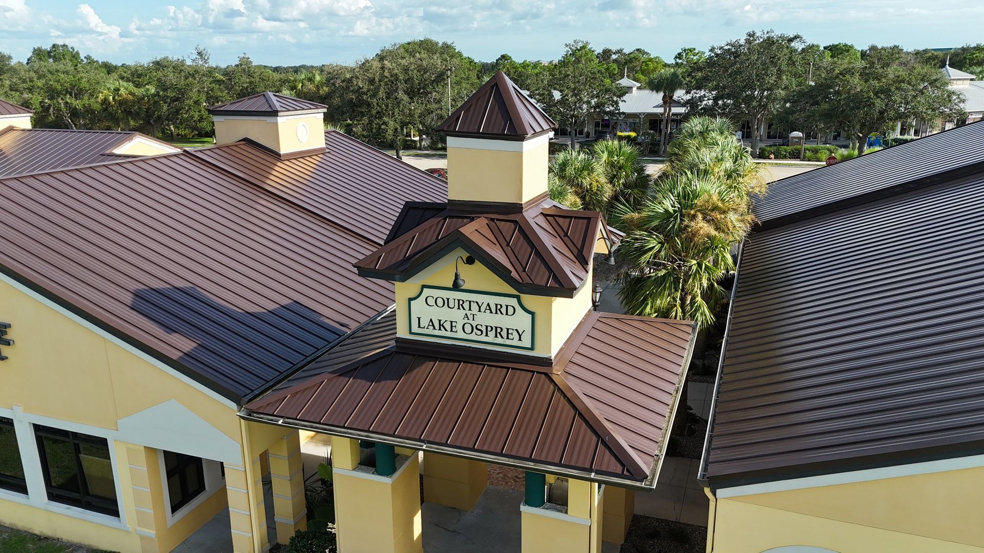 Yellow building with brown metal roof.