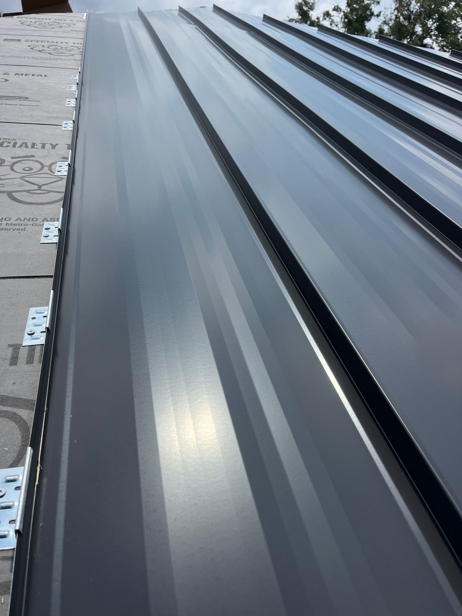 A close up of a black metal roof