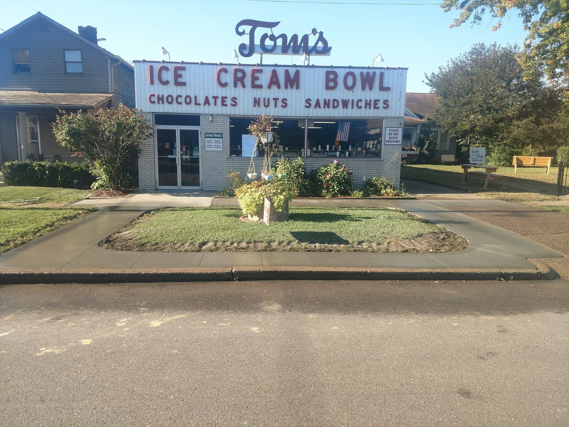 A sign for tom's ice cream bowl chocolates nuts and sandwiches