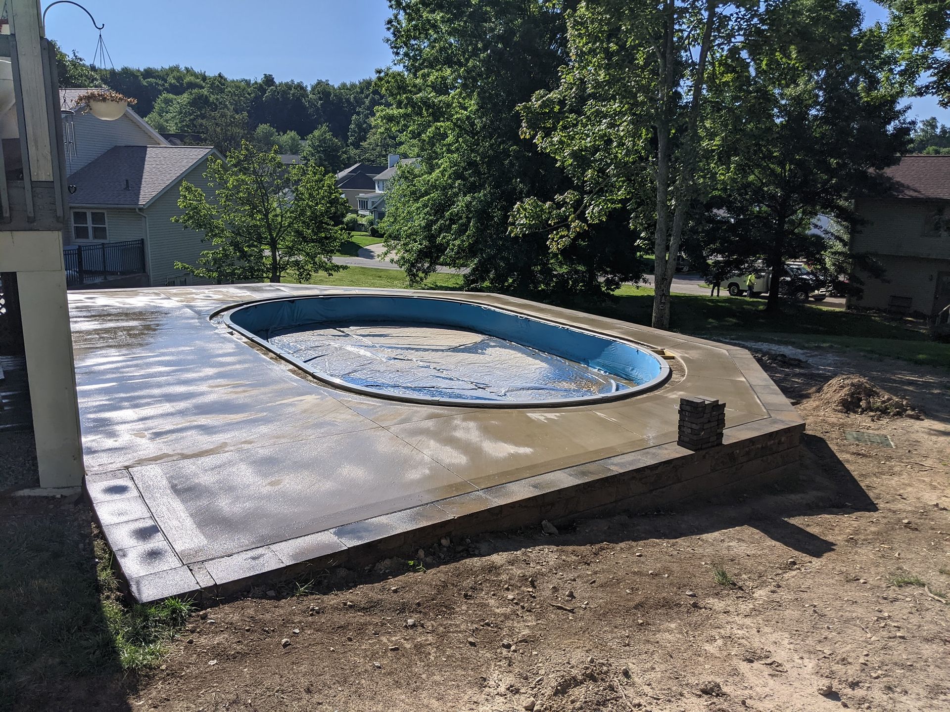 A swimming pool is sitting on top of a concrete platform.