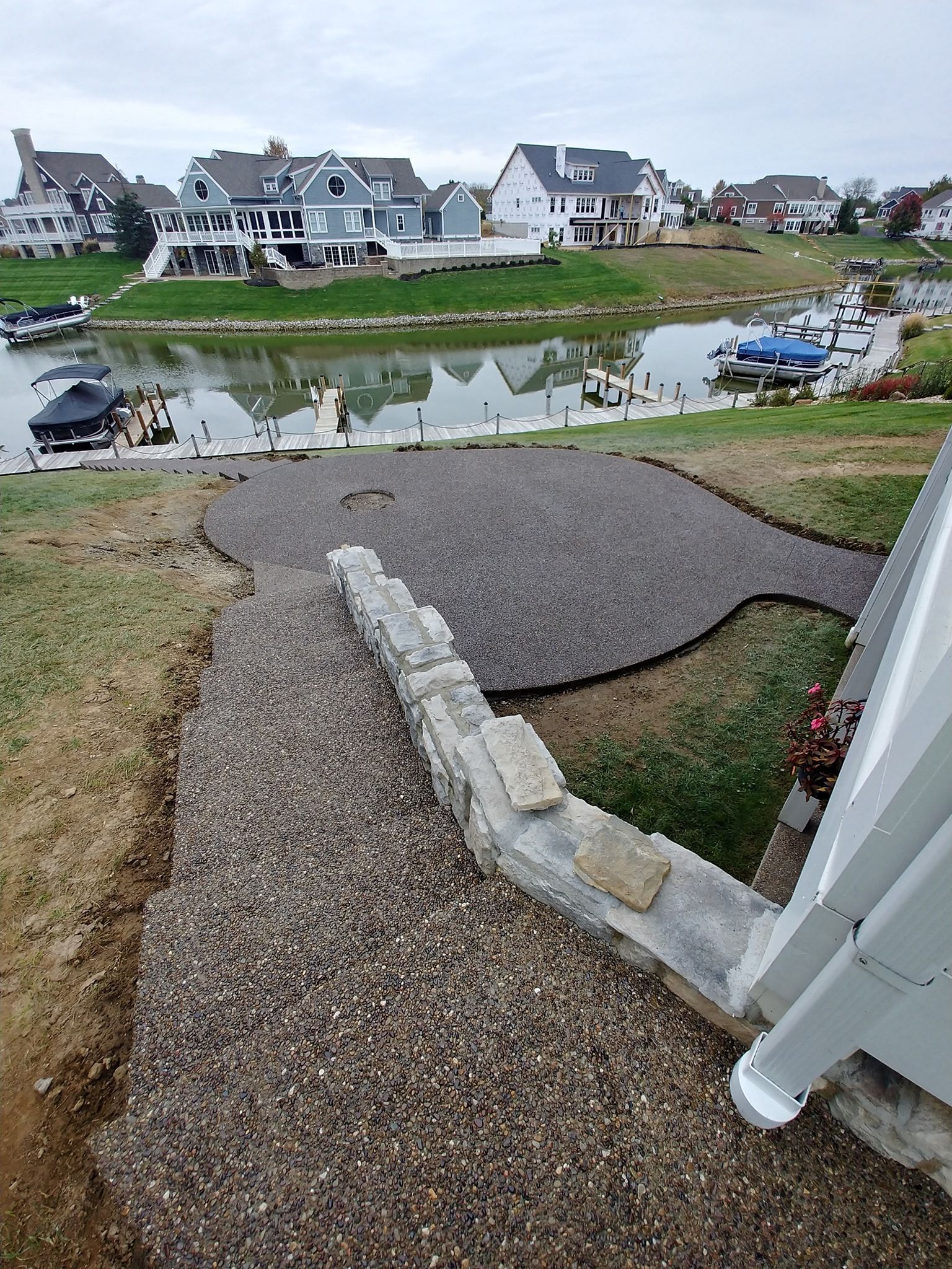 large exposed agg patio and a lot of steps to patio to dock.