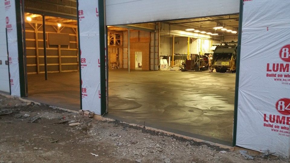 A large warehouse with a large garage door is being built.