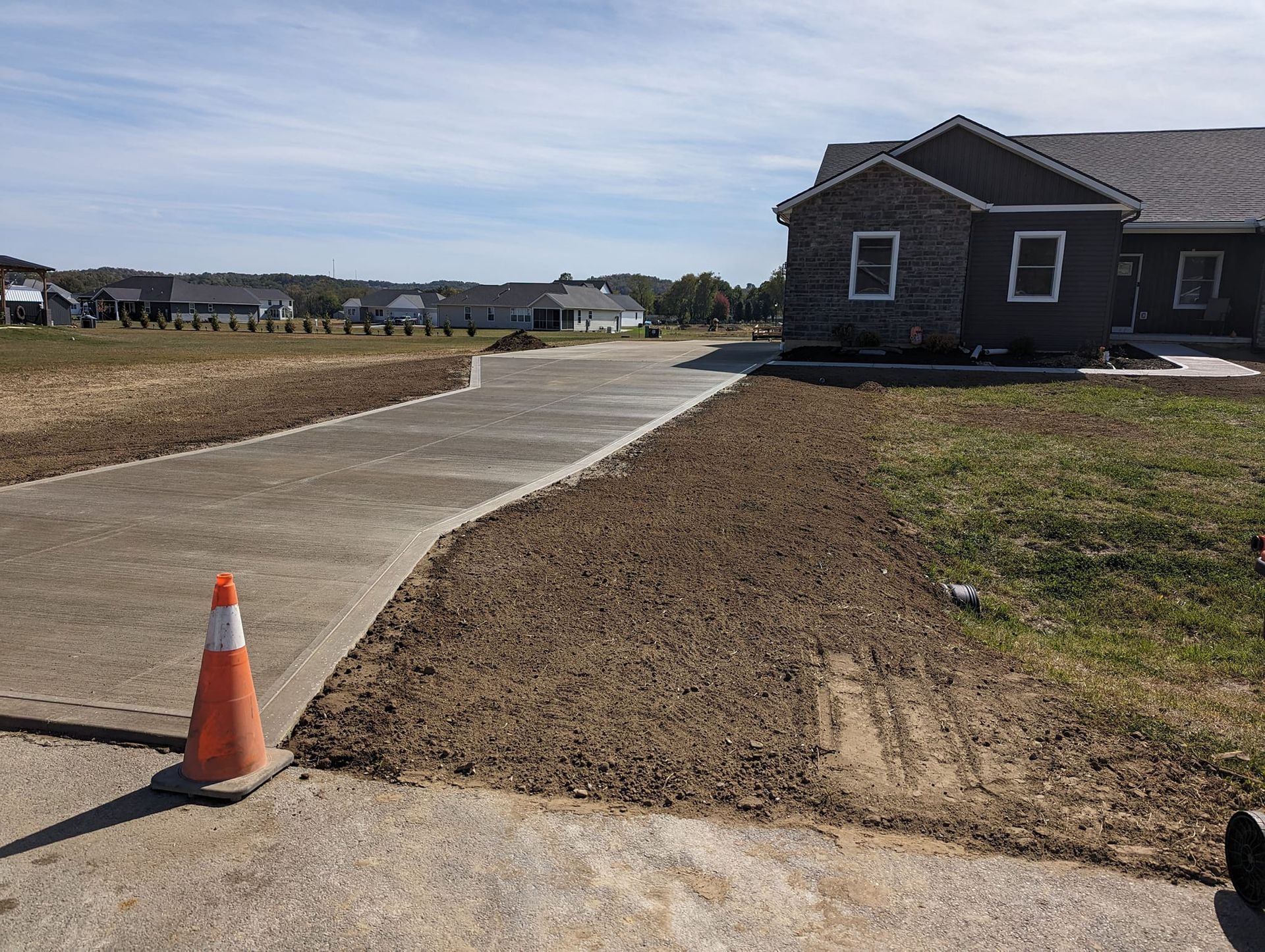 A concrete driveway is being built in front of a house.