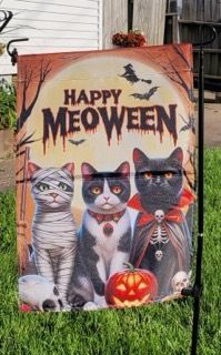 A happy meoween sign with three cats and pumpkins on it.