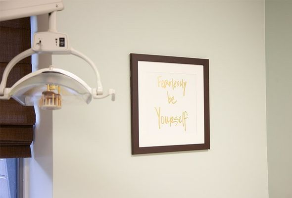 Dental office interior with light fixture and framed print that reads 