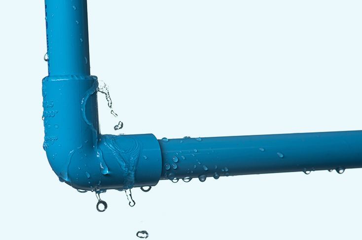 A blue pipe is leaking water on a white background.