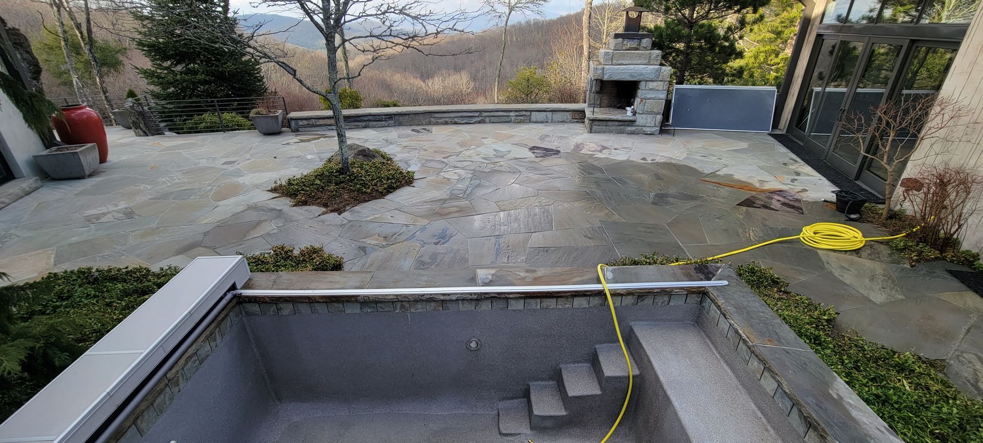 A swimming pool is being built in the backyard of a house.