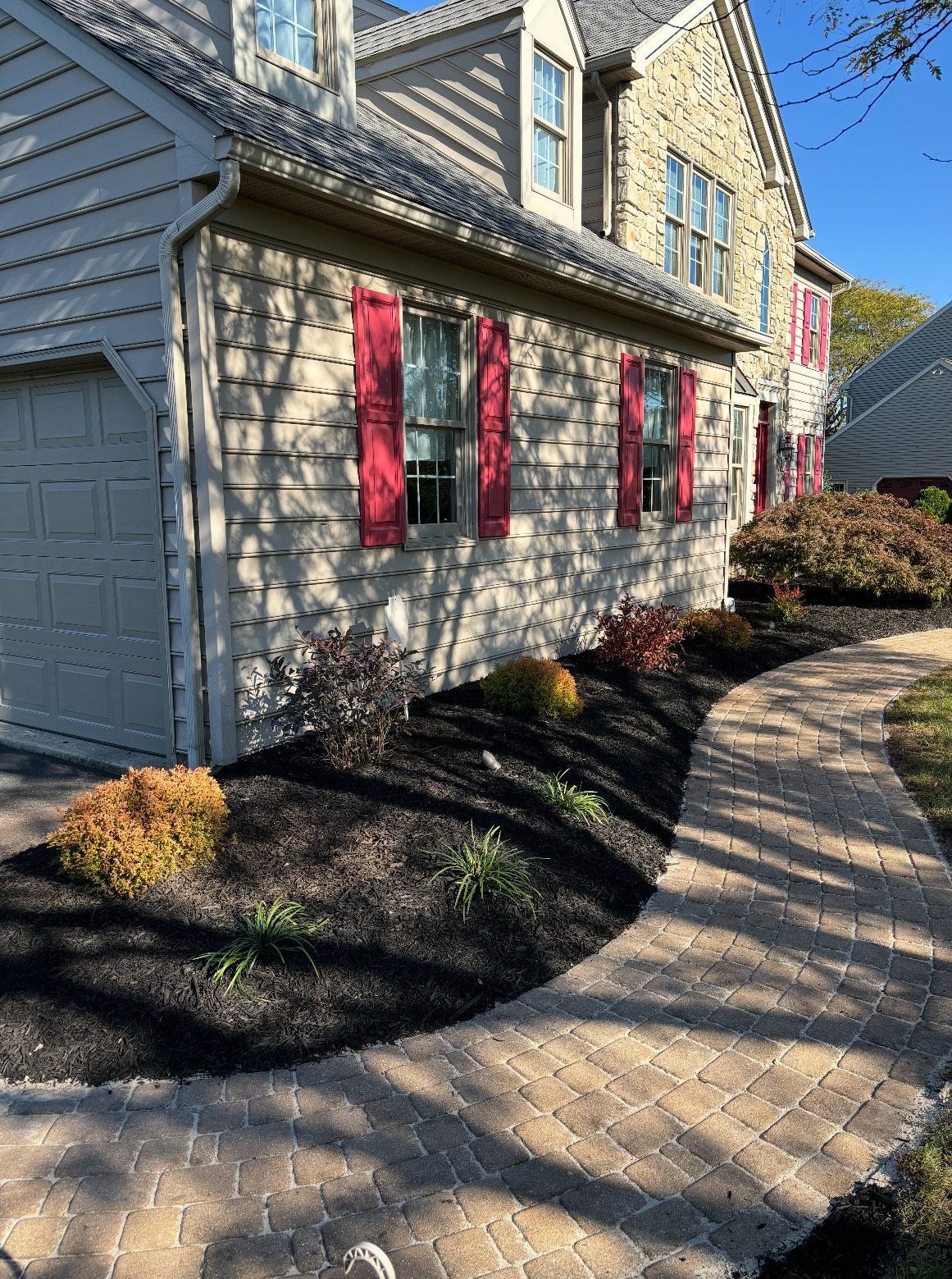 There is a walkway leading to the front of the house.