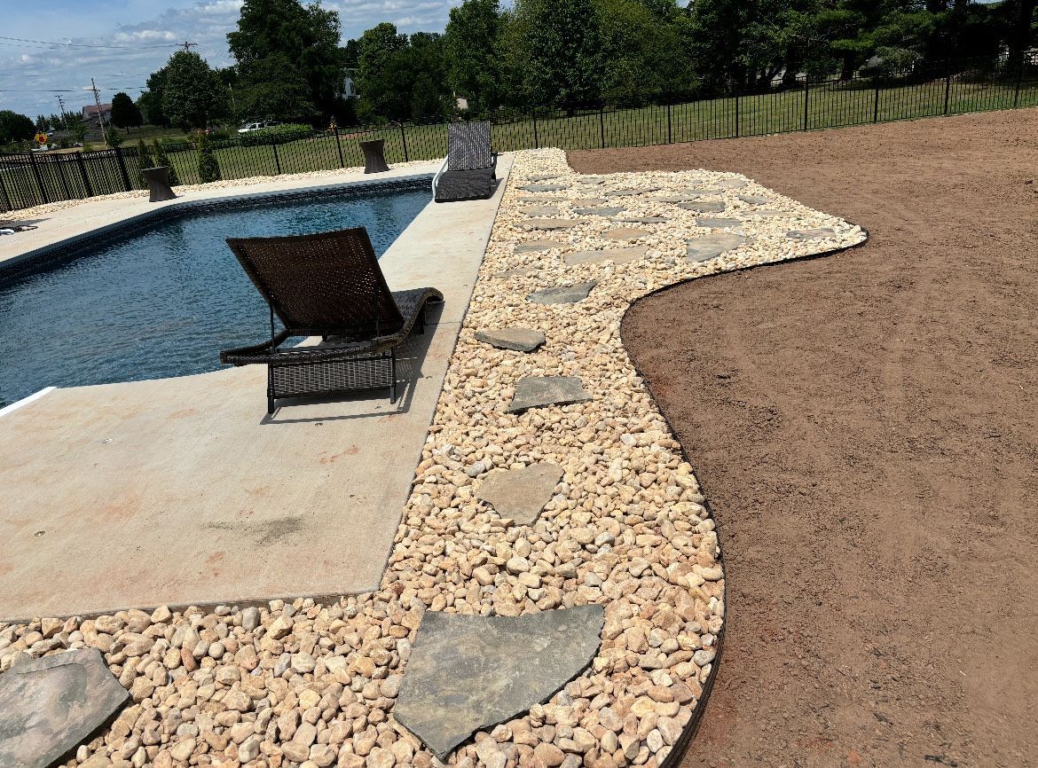 A lawn chair is sitting next to a swimming pool.
