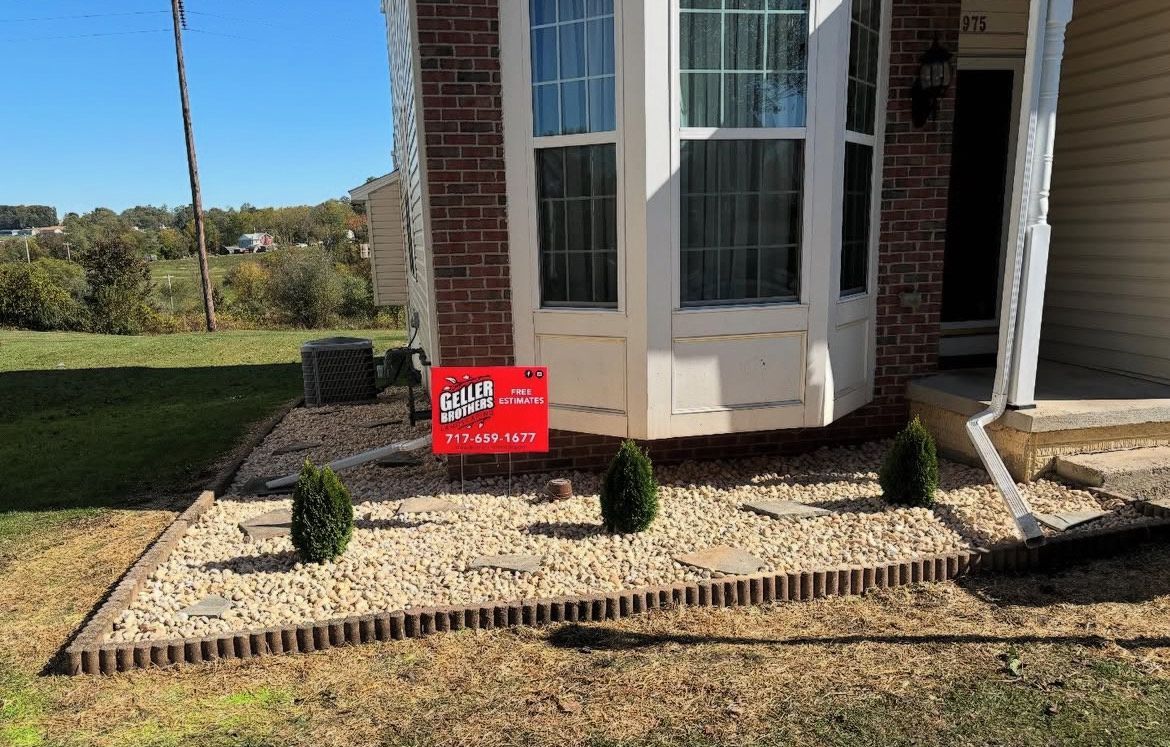 A house with a for sale sign in front of it.