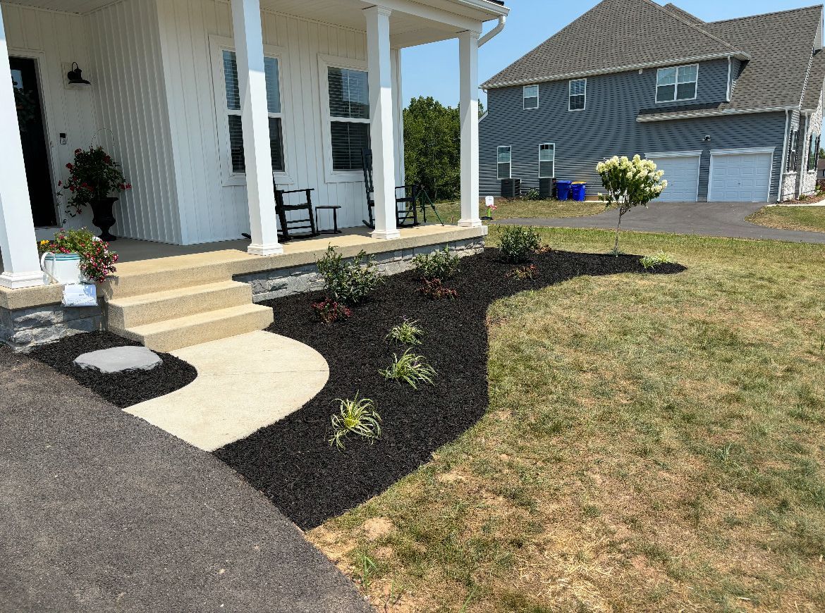 A house with a porch and a walkway in front of it.