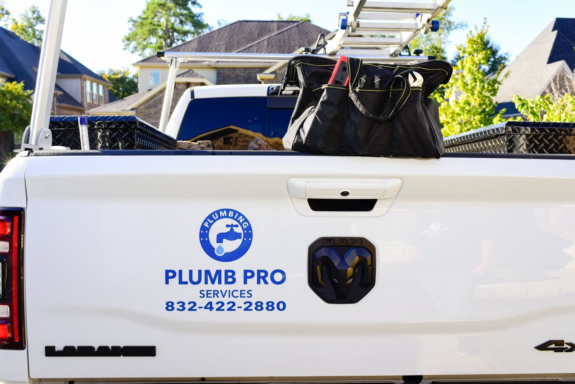 The back of a white truck with plumb pro services written on it