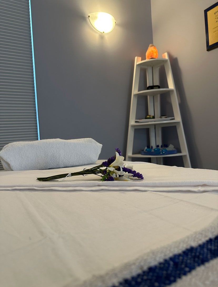 A bedroom with a bed and an organizer in the corner