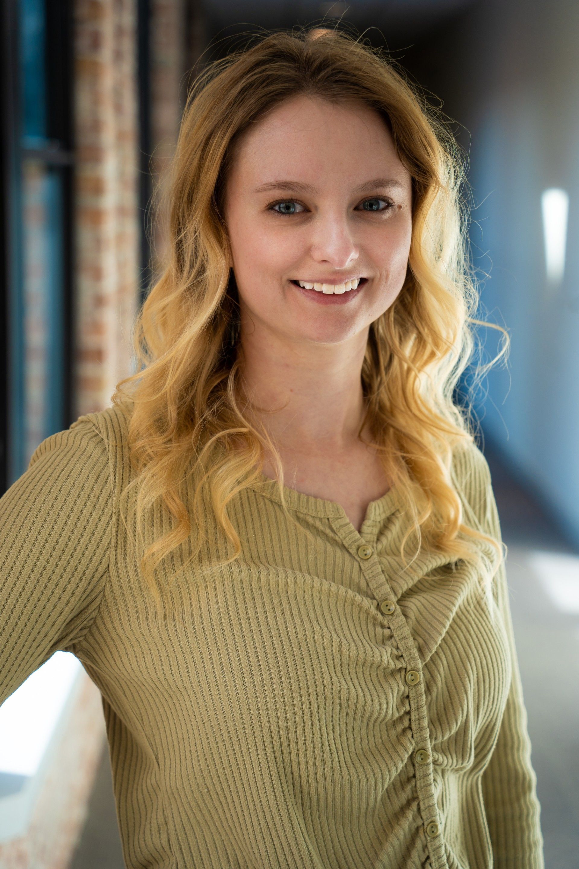 Christy Lyle-Whipple, LMSW is wearing a green shirt and smiling for the camera.