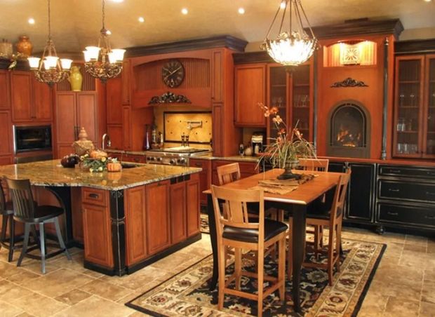 Elegant kitchen with wood cabinets, granite countertops, and dining table.