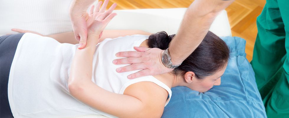 man massaging the woman's back