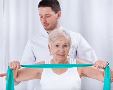 man stretching the old woman's arms