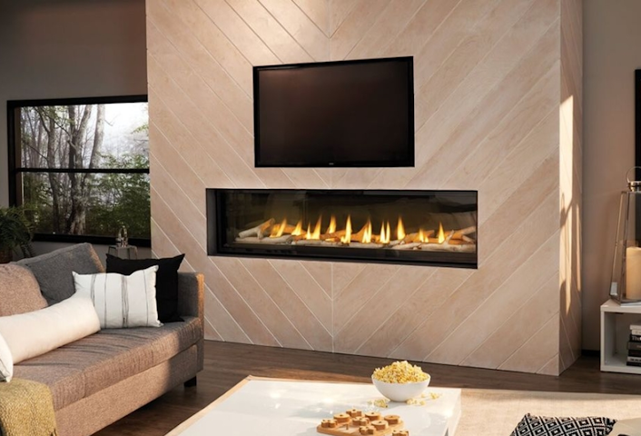Modern living room with a wall-mounted fireplace, TV, gray sofa, and large windows