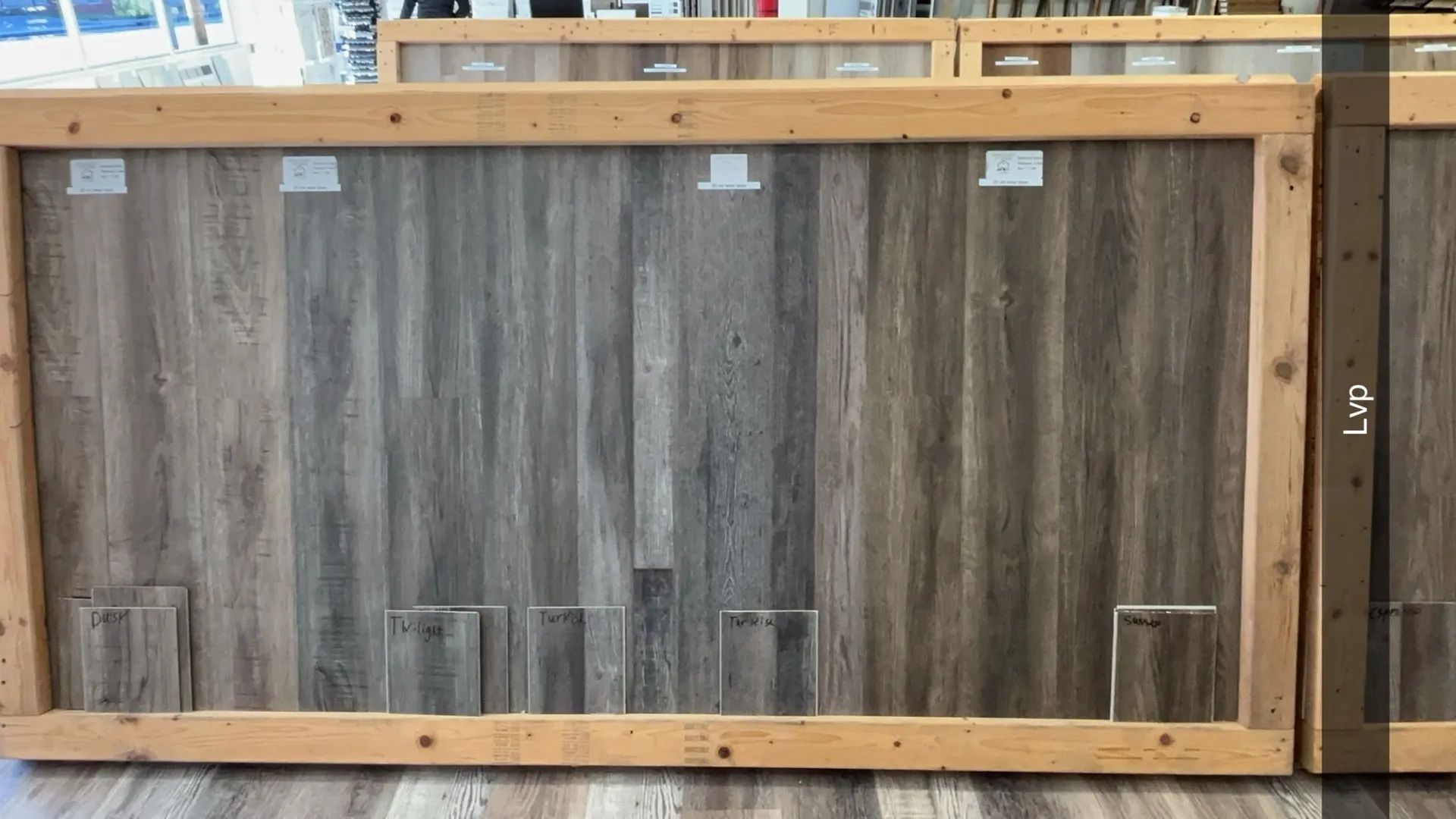 Wooden framed display showing various wood samples.