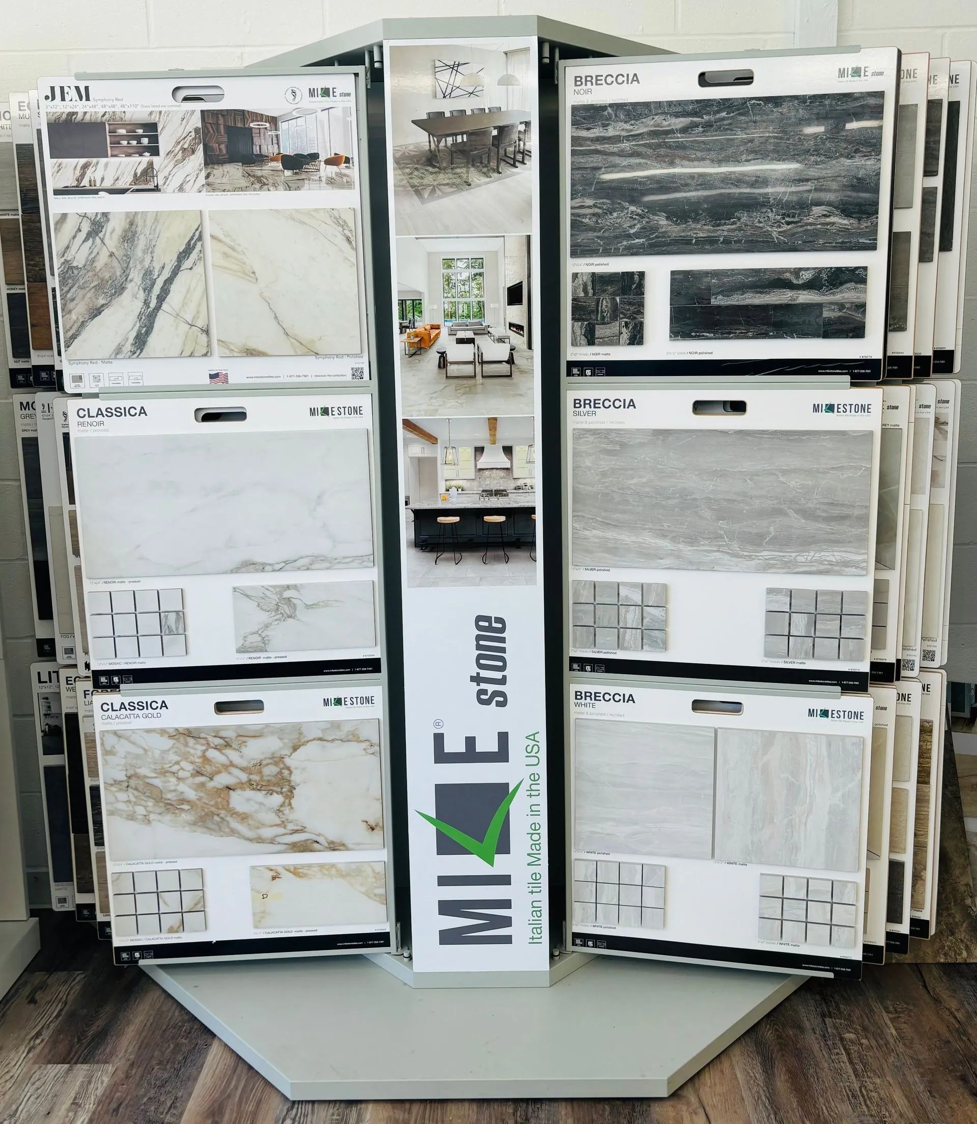 Rotating tile display featuring various stone samples. The display has a hexagonal base and is in a store.