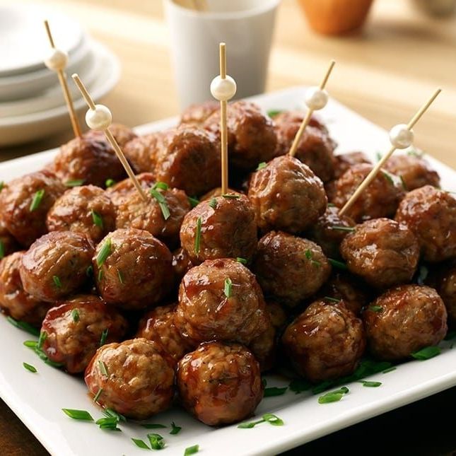 A plate of meatballs with toothpicks in them