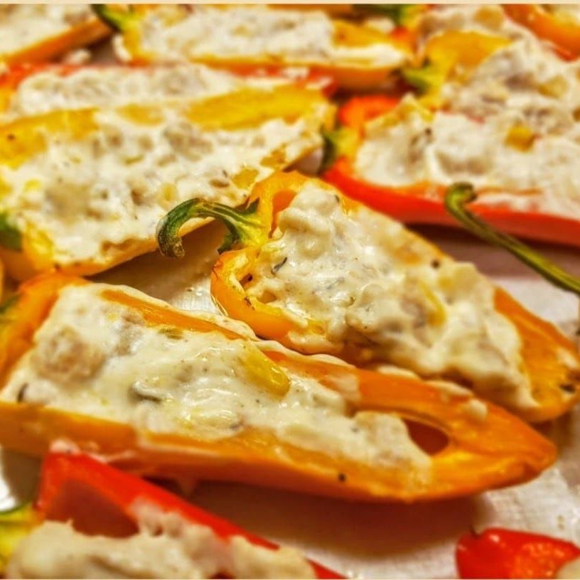 A bunch of stuffed peppers are sitting on a table