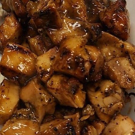 A close up of a plate of chicken with sauce on it