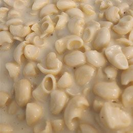 A close-up of macaroni and cheese in a creamy sauce.