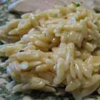 A close up of a plate of rice on a table.