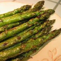 A close up of a plate of asparagus on a table.