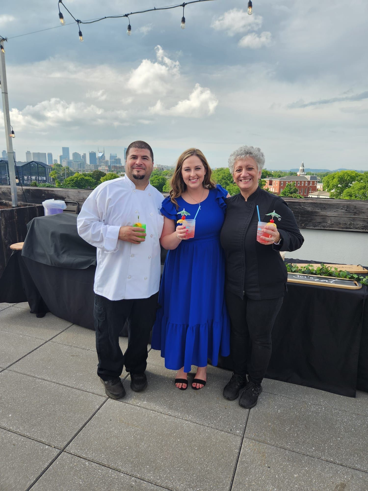 A group of people standing next to each other on a rooftop.