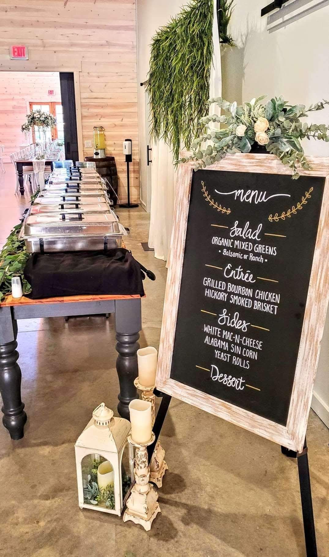 A buffet table with a menu on a chalkboard in front of it