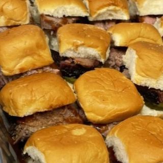 A bunch of hamburger sliders sitting on top of each other