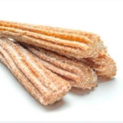 A close up of a stack of churros on a white surface.