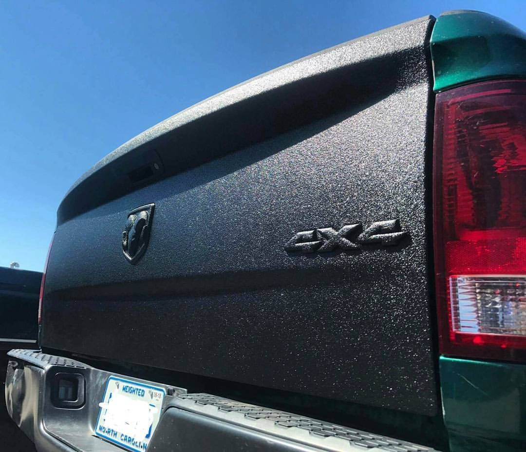 The back of a green truck with the word 4x4 on it.