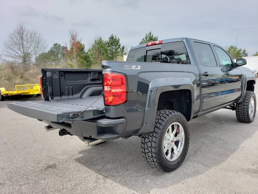 A black pickup truck is parked on the side of the road.