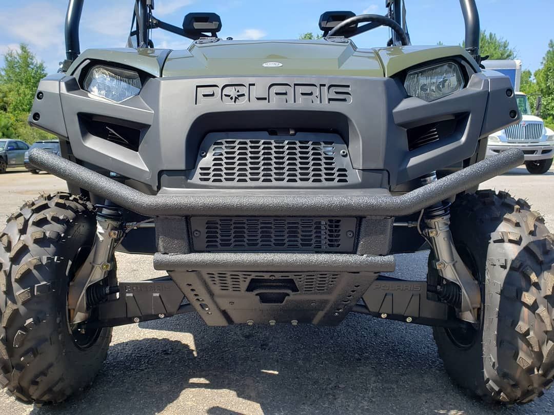 A polaris atv is parked in a parking lot.