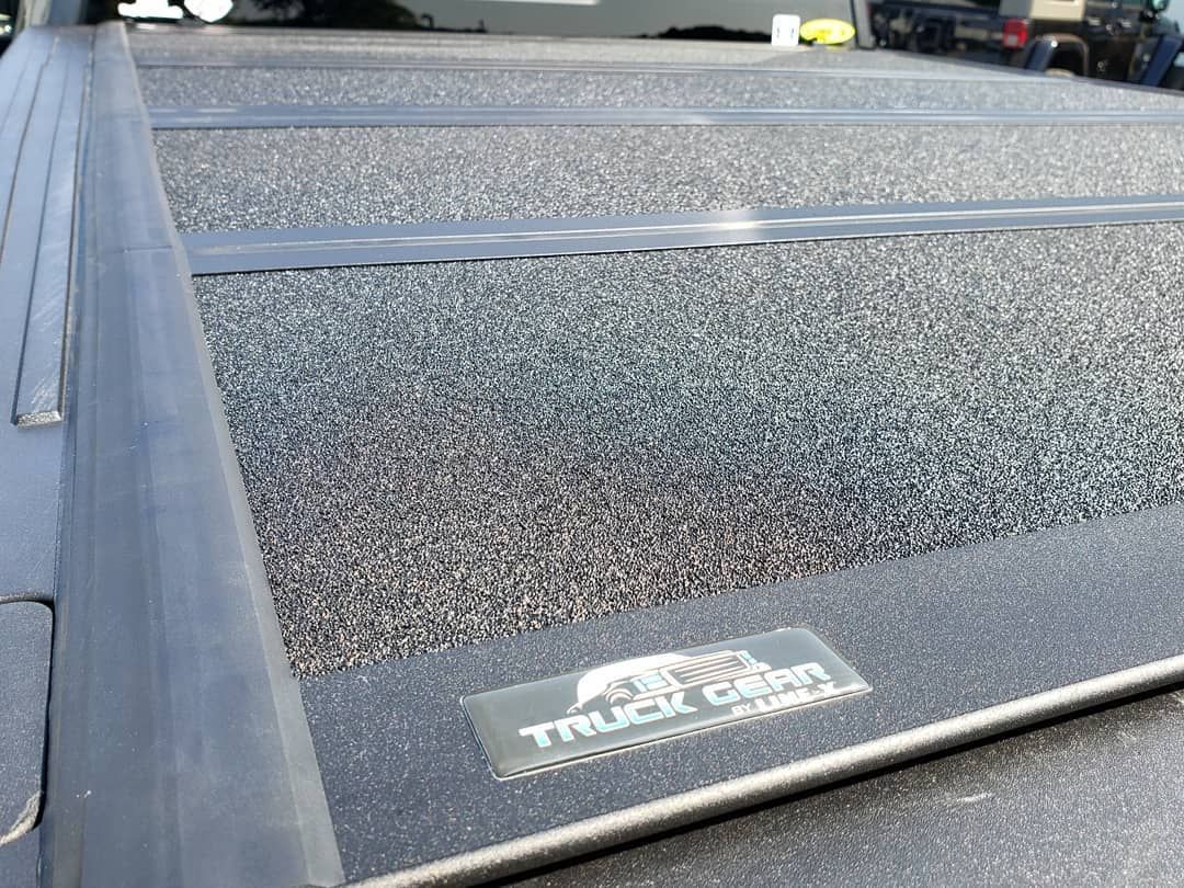 A close up of a truck bed cover on a truck.