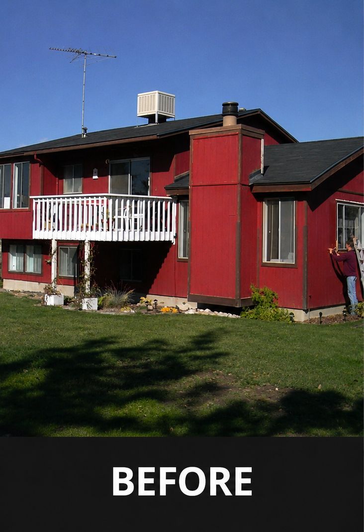 Red two-story house with a white balcony in daylight