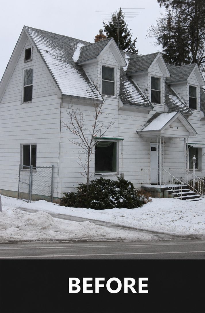 Snow-covered white house with steep gabled roof